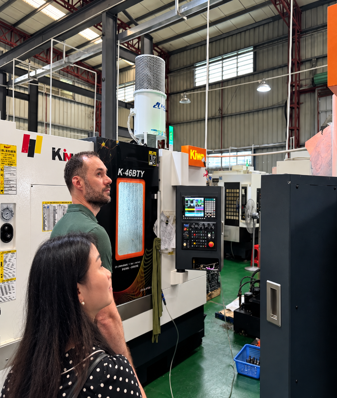 Visitors reviewing CNC machining equipment at the LXCET workshop